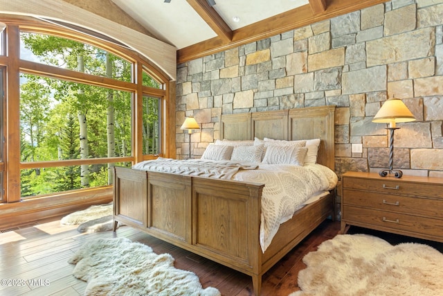 bedroom featuring hardwood / wood-style flooring and lofted ceiling with beams