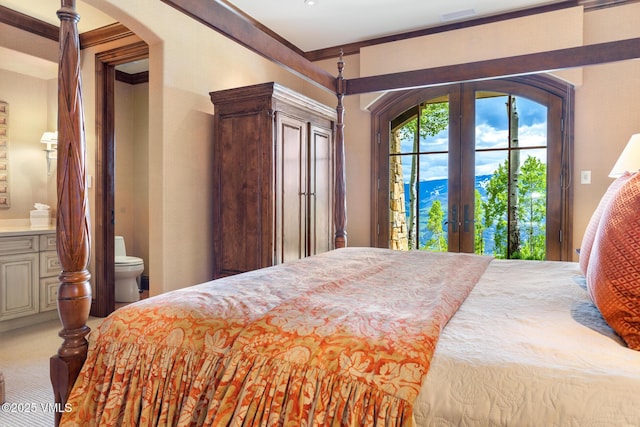 bedroom with french doors, ensuite bathroom, access to outside, a mountain view, and carpet floors