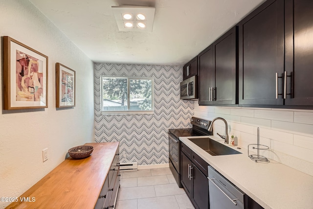 871 W Beaver Creek Blvd Unit A9, Avon, CO 81620 - kitchen with stainless steel appliances, a sink, butcher block counters, baseboard heating, and light tile patterned floors