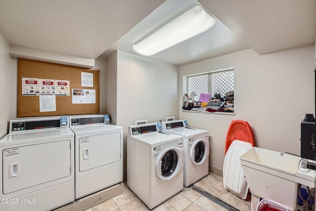 871 W Beaver Creek Blvd Unit A9, Avon, CO 81620 - community laundry with washing machine and clothes dryer, light tile patterned floors, and baseboards
