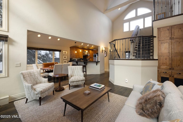 living room featuring dark wood-type flooring and high vaulted ceiling