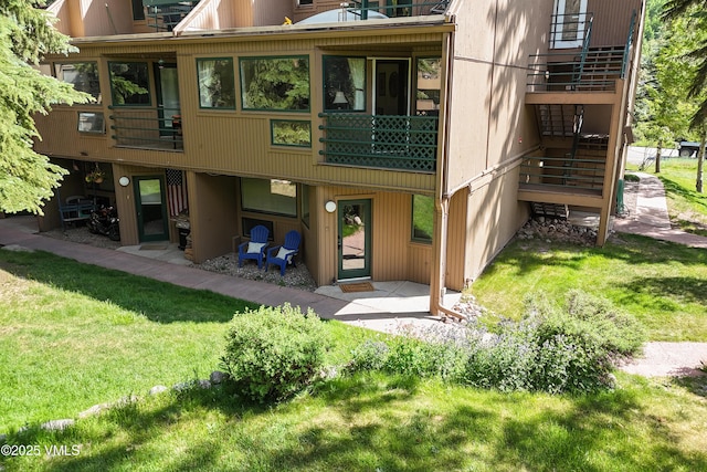 3931 Bighorn Rd Unit 5-E, Vail, CO 81657 - rear view of house with a lawn and stairway
