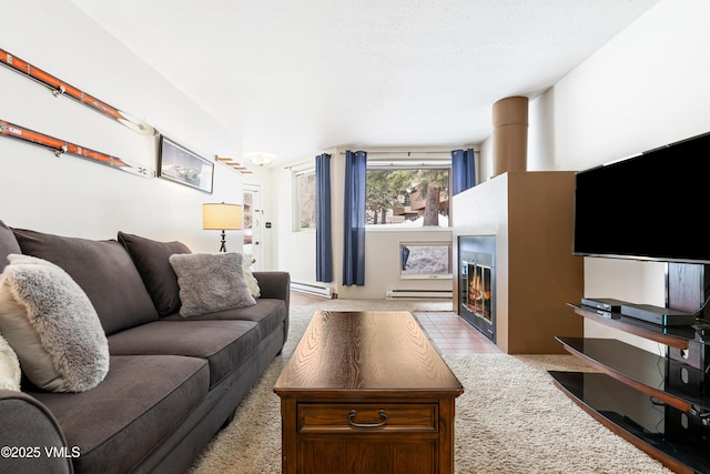 3931 Bighorn Rd Unit 5-E, Vail, CO 81657 - living room featuring baseboard heating, a fireplace with flush hearth, and light carpet
