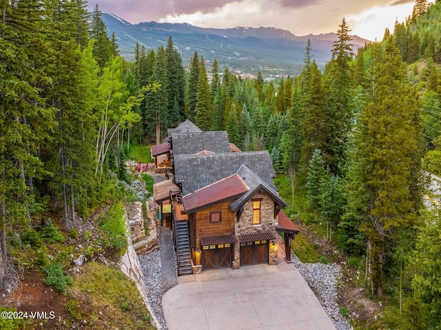 aerial view at dusk featuring a mountain view