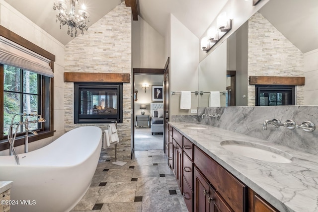 bathroom with a multi sided fireplace, a tub to relax in, high vaulted ceiling, and vanity