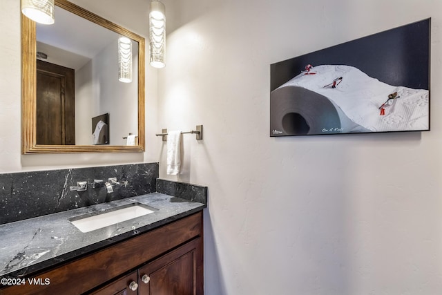 bathroom featuring vanity and tasteful backsplash