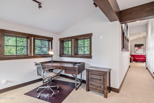 carpeted office space featuring vaulted ceiling with beams