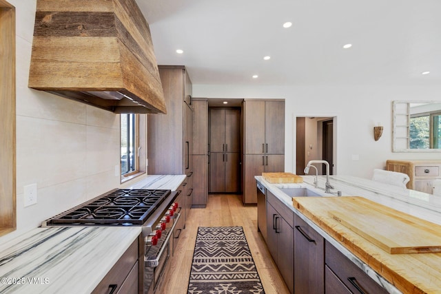 2036 Vermont Rd, Vail, CO 81657 - kitchen featuring custom range hood, a sink, light countertops, recessed lighting, and light wood finished floors