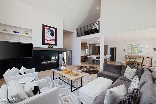 2036 Vermont Rd, Vail, CO 81657 - living room with a towering ceiling, built in features, recessed lighting, and light wood-type flooring