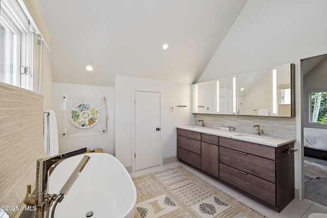 2036 Vermont Rd, Vail, CO 81657 - full bath with a freestanding bath, double vanity, decorative backsplash, recessed lighting, and high vaulted ceiling