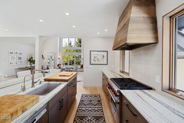 2036 Vermont Rd, Vail, CO 81657 - kitchen with a sink, recessed lighting, dark brown cabinetry, premium range hood, and stainless steel appliances