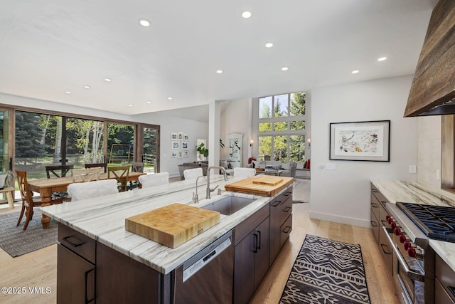 2036 Vermont Rd, Vail, CO 81657 - kitchen featuring appliances with stainless steel finishes, a sink, recessed lighting, light wood-style flooring, and a kitchen island with sink