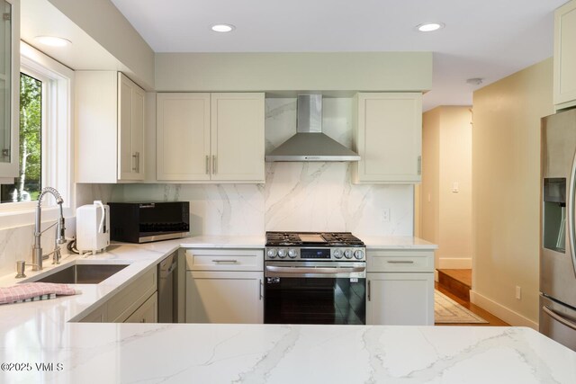 50 Hereford Rd, Edwards, CO 81632 - kitchen with wall chimney range hood, stainless steel appliances, light stone counters, tasteful backsplash, and recessed lighting