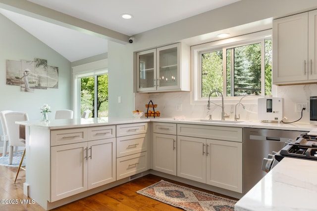 50 Hereford Rd, Edwards, CO 81632 - kitchen with a peninsula, light countertops, tasteful backsplash, lofted ceiling, and glass insert cabinets