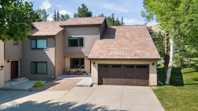50 Hereford Rd, Edwards, CO 81632 - view of front of house featuring concrete driveway, a front yard, and a garage