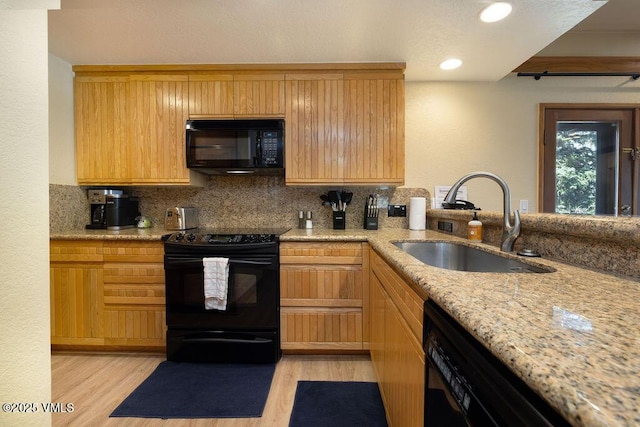 120 Offerson Rd Unit 3002, Beaver Creek, CO 81620 - kitchen with black appliances, a sink, light wood-type flooring, light stone countertops, and backsplash