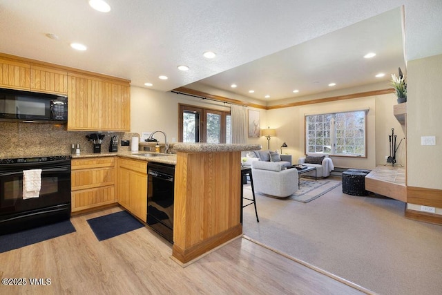 120 Offerson Rd Unit 3002, Beaver Creek, CO 81620 - kitchen with black appliances, a sink, open floor plan, healthy amount of natural light, and recessed lighting
