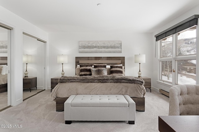 carpeted bedroom featuring a baseboard heating unit and baseboards