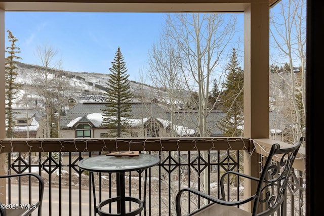 view of snow covered back of property