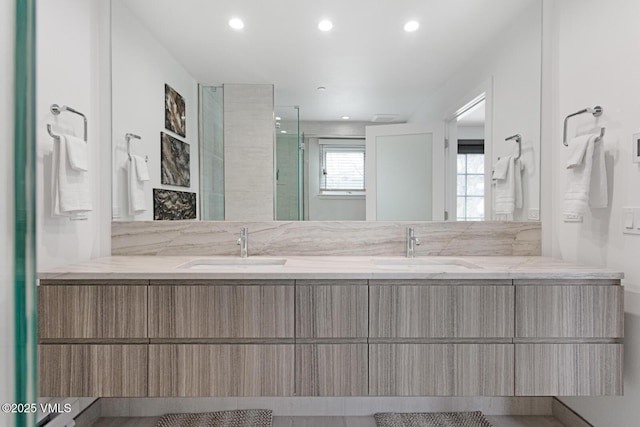 full bathroom with a sink, recessed lighting, and double vanity