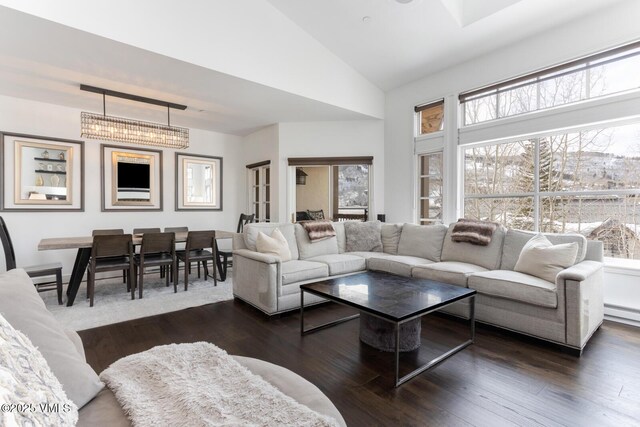 living room with dark wood-style floors, a baseboard heating unit, and lofted ceiling