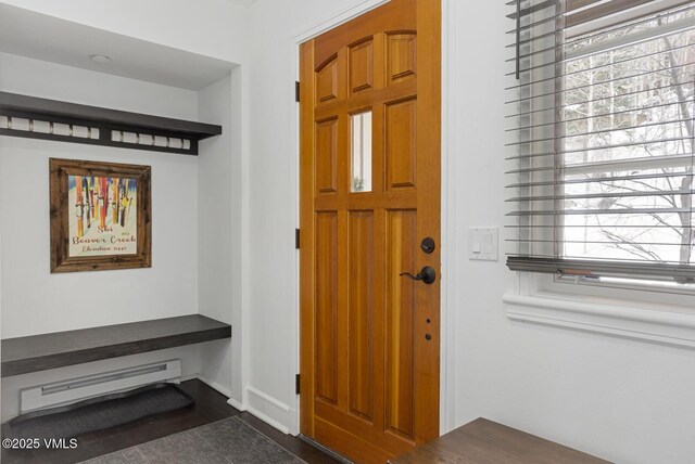 foyer entrance with a baseboard heating unit