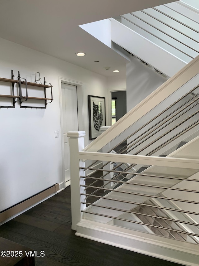 stairs featuring recessed lighting and wood finished floors