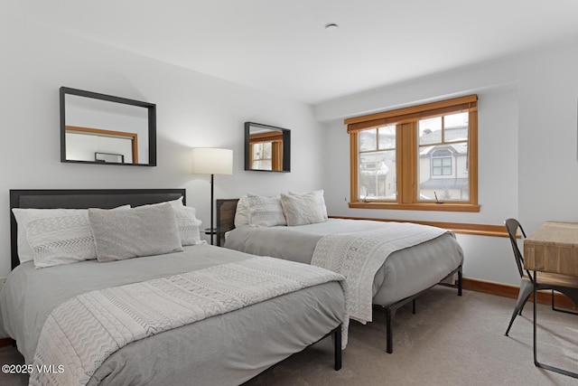 bedroom with baseboards and carpet floors