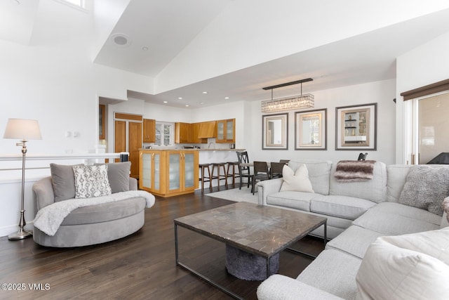 living room with dark wood-style floors, recessed lighting, and high vaulted ceiling