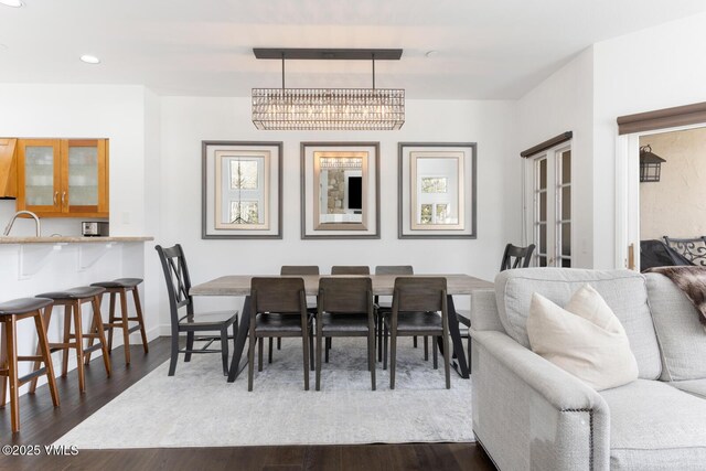 dining space with baseboards, recessed lighting, french doors, an inviting chandelier, and dark wood-style floors