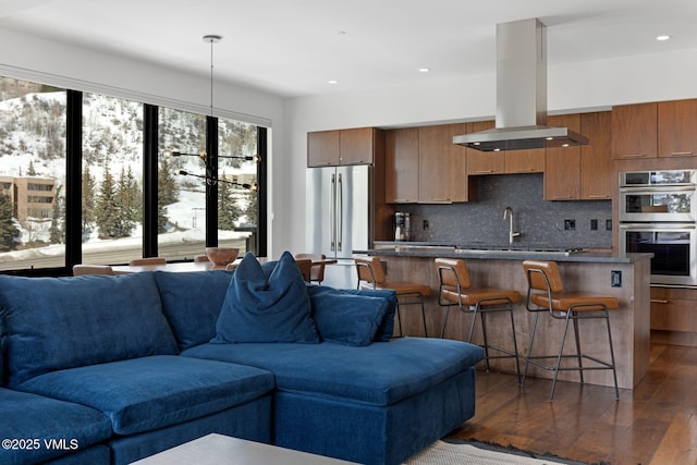 living room with recessed lighting and dark wood-style floors