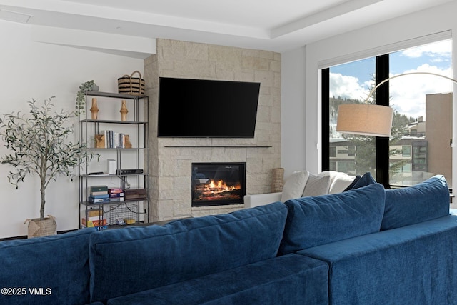 living area with a stone fireplace