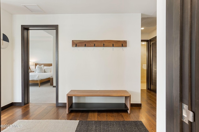 mudroom with dark wood-style floors, visible vents, and baseboards