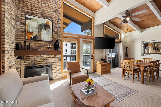 carpeted living area with beam ceiling, high vaulted ceiling, a brick fireplace, and wooden ceiling