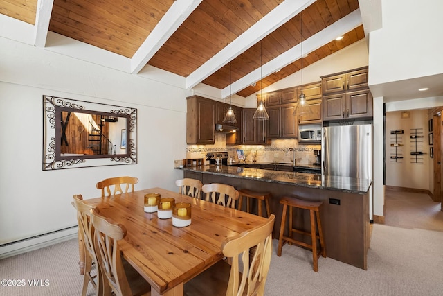 dining area featuring lofted ceiling with beams, light colored carpet, wooden ceiling, and a baseboard radiator