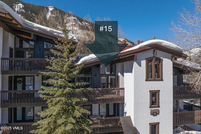 snow covered property featuring a mountain view