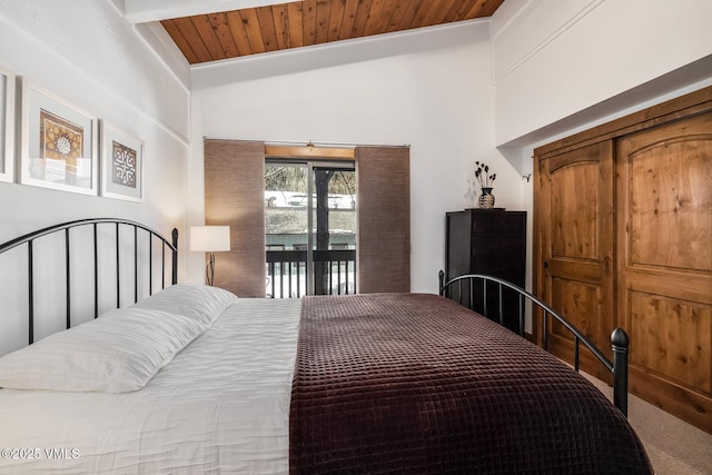 bedroom with access to exterior, wooden ceiling, and vaulted ceiling