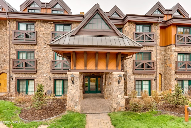 434 S Frontage Rd E Unit 403, Vail, CO 81657 - view of front of property with a standing seam roof, stone siding, french doors, and a metal roof