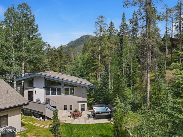 4916 Juniper Ln, Vail, CO 81657 - back of house featuring a wooded view, a patio, a shingled roof, a yard, and stairs