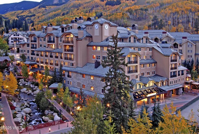 birds eye view of property with a mountain view