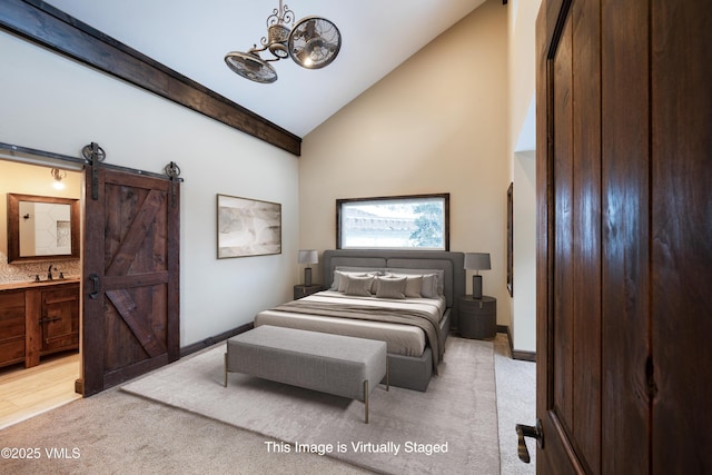 4595 Bighorn Rd Unit 5, Vail, CO 81657 - bedroom with light colored carpet, a chandelier, a barn door, high vaulted ceiling, and ensuite bath