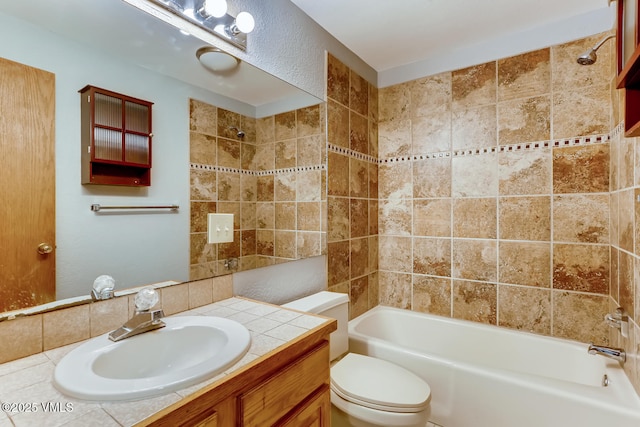 full bathroom with tiled shower / bath, vanity, and toilet