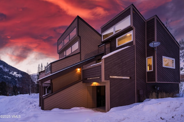 snow covered property featuring a mountain view