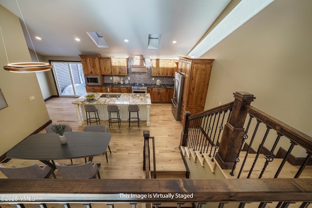 4595 Bighorn Rd Unit 5, Vail, CO 81657 - dining area with light wood-style floors, recessed lighting, and stairs