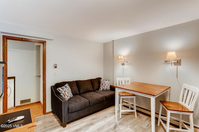 living room featuring light hardwood / wood-style floors and baseboard heating