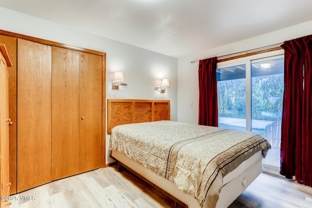 bedroom with access to exterior and light wood-type flooring