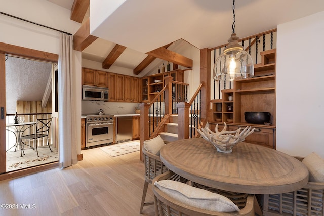 dining area with vaulted ceiling with beams and light wood-type flooring