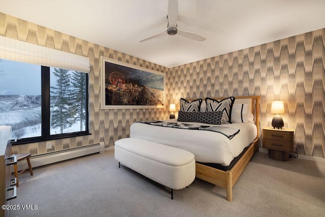 bedroom with wallpapered walls, baseboards, a baseboard radiator, ceiling fan, and carpet