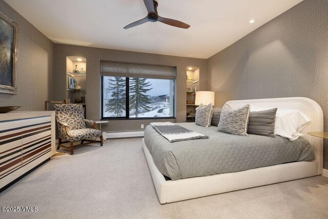 bedroom with a textured wall, carpet, ceiling fan, and a baseboard radiator