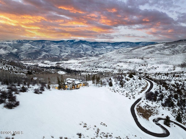 snowy aerial view with a mountain view